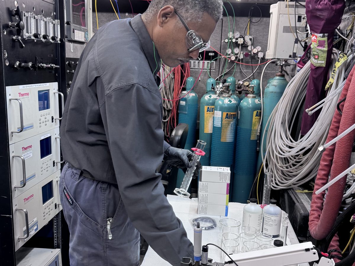 AccuEnviro technician preparing sampling equipment in the mobile laboratory